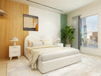 Beige upholstered bed with rounded headboard and wooden legs – Reverie frame.