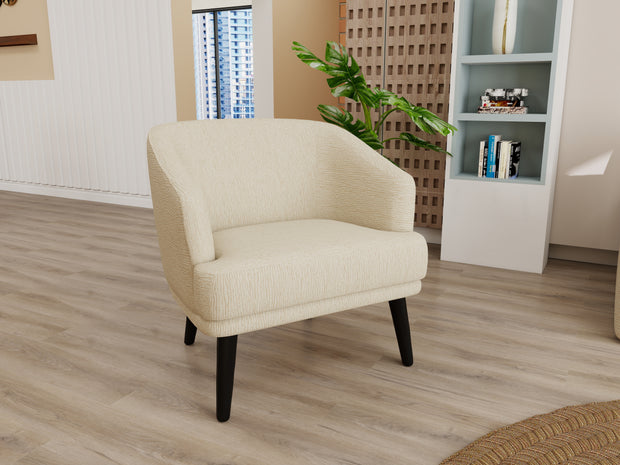 Handloom beige armchair with sculpted tub back and dark tapered legs in a modern living room.