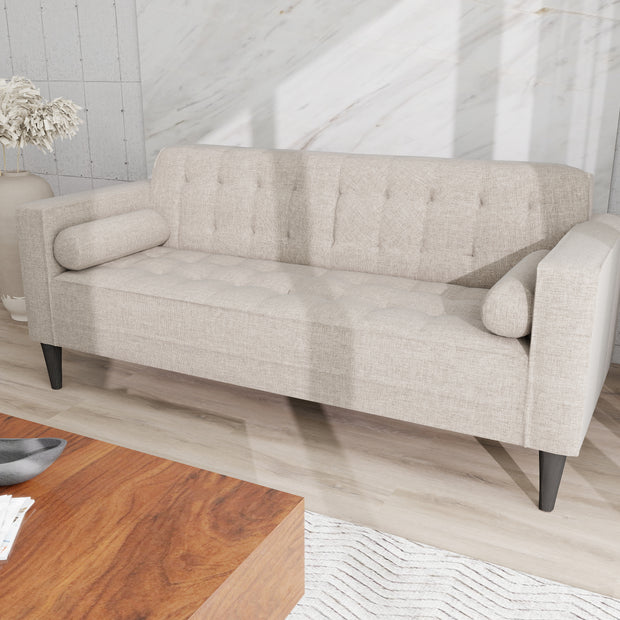 Arcadia grey 3-seater fabric sofa with tufted back and seat, bolster cushions, and dark tapered legs.