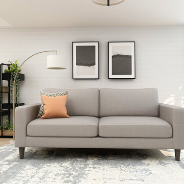 Grey 3-seater fabric sofa with tufted back and dark tapered wooden legs – The Grid.