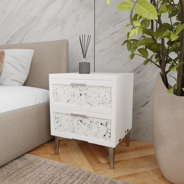 Slate nightstand styled next to an upholstered bed in a modern bedroom